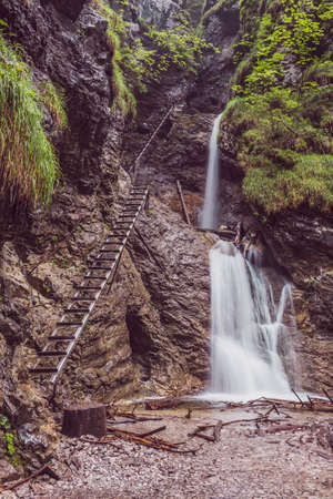 108/5000 Waterfall in the National Park - Slovak Paradise. Ladder on the trail in the rock gorge, leading up the waterfall.の写真素材