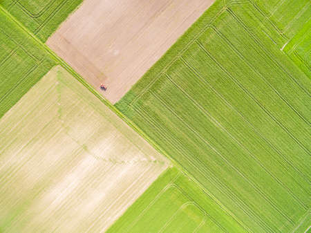 A landscape of farmland seen from the air. Abstract wallpaper - agricultural areas from a bird's eye view.の写真素材
