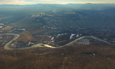 Aerial view of the village over a winding river. Autumn landscape.