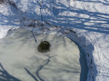 Photo of wellspring in the winter woods. Aerial top view.の写真素材