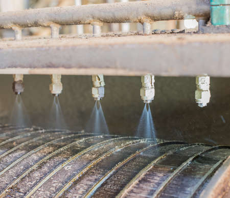 The injectors spray water on the contaminated drum.