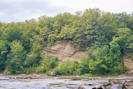 Sandstone outcrops in the steep bank of the river. River Pshekha. Russia, Krasnodar region.の写真素材