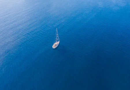 A lone sailing boat at anchor. The view from the air. Drone photo.の写真素材