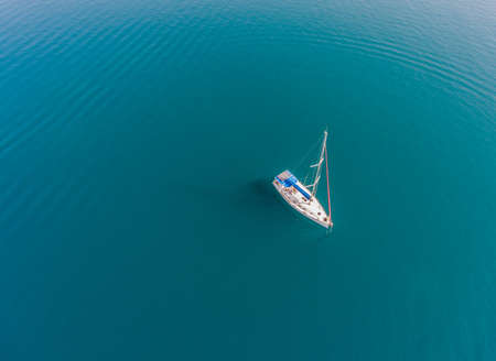 A lone sailing vessel at anchorage. Aerial top view.の写真素材