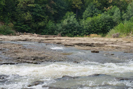 Naked bottom of a shallow mountain river.の写真素材