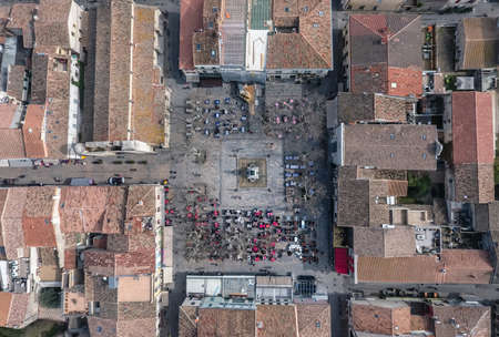 Square with restaurants in the center of the fortress town Aigues-Mortes in France. Aeria top view.の写真素材