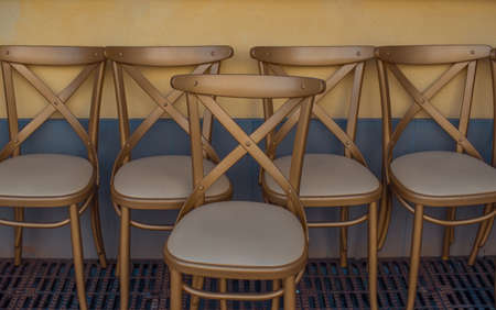 Gold chairs along the wall outside the restaurant.