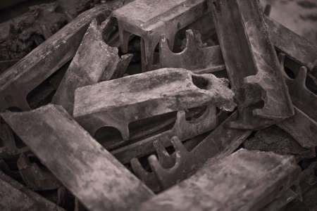 Pile of burnt-out cast cast iron details of the grate firing industrial firebox. Selective focus.