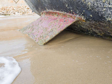 Sailing boat on the beach leans on the keel. Selective focus.