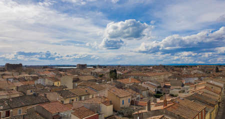 Tiled roofs of houses of the old French city under the cloudy sky.の写真素材