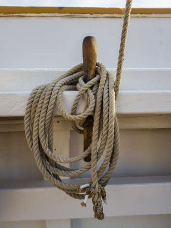 Nagel and coil of rope on the white board of the old schooner.