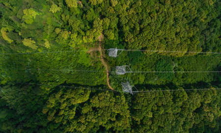 Aerial view. High voltage metal post. High-voltage towers in the forest. Top view.の写真素材