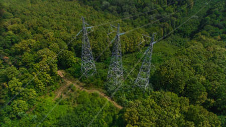 Aerial view. High voltage metal post. High-voltage towers in the forest.の写真素材