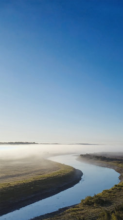 Beautiful morning landscape with fog over the river and blue sky.の素材