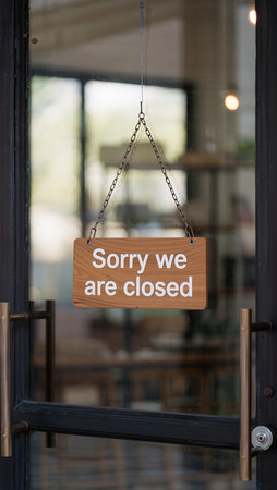 Empty wooden signboard hanging on the door of a cafe with textの素材