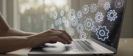 Close up of businesswoman hand working on laptop computer with gear icon diagramの素材