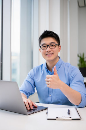 Young Asian businessman working with laptop computer at office. Business success concept.の素材