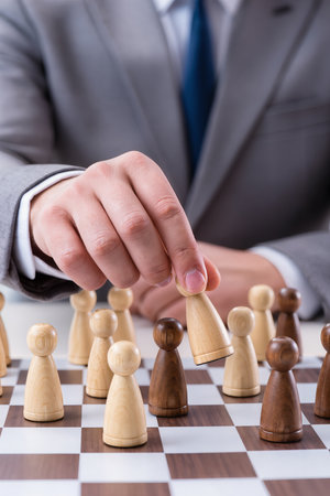 Businessman playing chess, close-up. Concept of business strategyの素材