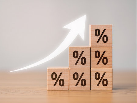 Percentage symbol on wooden cubes with white background, business and finance conceptの素材
