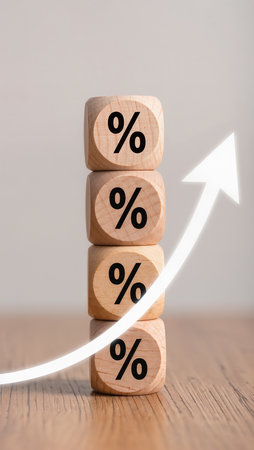 Wooden cubes with percentage symbol on wooden background. Concept of financial growthの素材