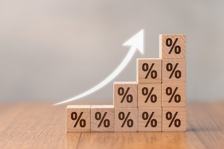 Wooden blocks with percentage sign on wooden table. Business growth conceptの素材