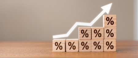 Wooden blocks with percentage symbol on wooden table. Business and finance conceptの素材