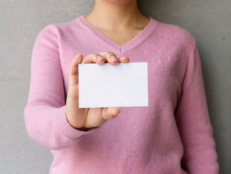 Woman holding blank business card, closeup. Mockup for designの素材