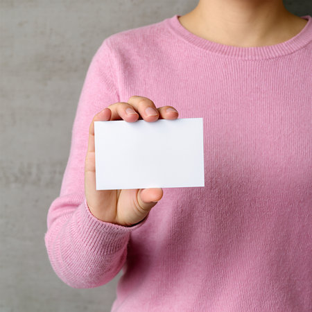 Woman showing blank business card, closeup. Mockup for designの素材