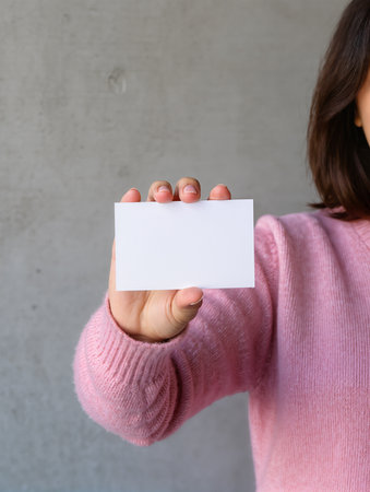Close up of business woman showing blank business card with copy space.の素材