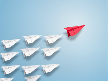 Leadership concept with red paper plane and white paper planes on blue backgroundの素材
