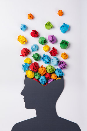 Paper man head with colorful crumpled paper balls as creativity conceptの素材