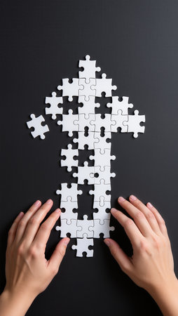 White jigsaw puzzle in the shape of a arrow on black backgroundの素材