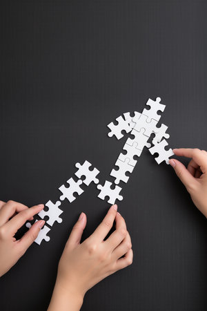 Close up of business people hands assembling jigsaw puzzle with missing pieceの素材