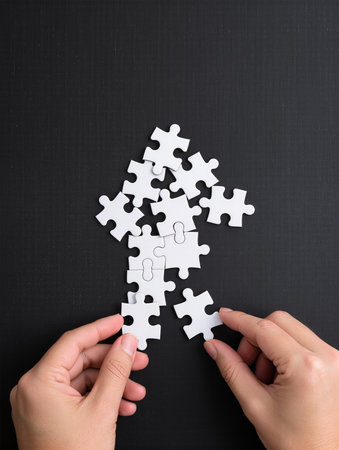 Hands connecting pieces of jigsaw puzzle. Business solution concept.の素材