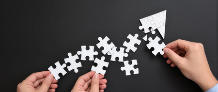 Hands connecting puzzle pieces. Teamwork, partnership and success conceptの素材