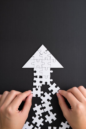 Hands assembling jigsaw puzzle with missing piece, business solutions conceptの素材