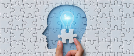 Human head with lightbulb and jigsaw puzzle pieces. Business solution conceptの素材