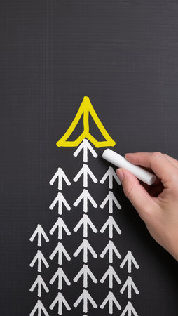 Businessman drawing a growing arrow on a blackboard with white chalkの素材