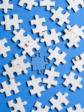 White jigsaw puzzle pieces on blue background. Business solution concept.の素材