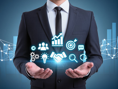Businessman holding digital business icons over his hands. Business strategy conceptの素材
