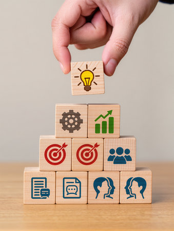 Wooden blocks with icons related to businesseting and technology.の素材