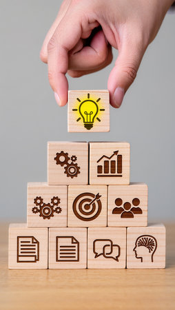 Hand arranging wood block stacking as step stair and light bulb icon on topの素材