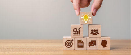 Concept of creative process with icons on wooden cubes over grey backgroundの素材