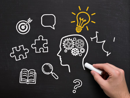 Business idea concept on a blackboard with a human head drawn with a chalkの素材