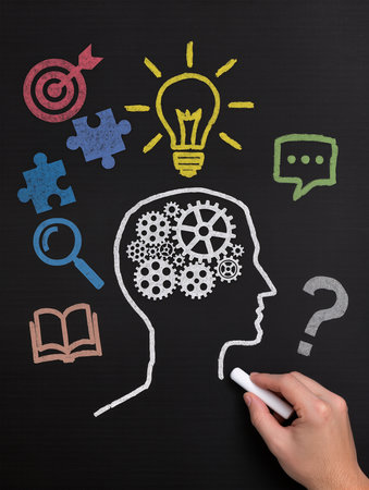 Human head with gears and lightbulb over chalkboard, education conceptの素材