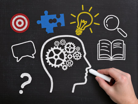 business idea concept on blackboard with hand drawing a head with gearsの素材