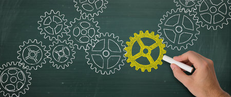 Teamwork concept with cogwheels on a blackboard with a chalkの素材