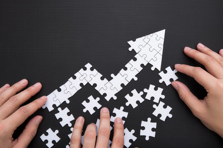 Hands connecting jigsaw puzzle pieces. Business success and growth conceptの素材