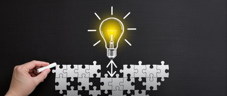 Hand drawing lightbulb with white chalk on blackboard, new idea conceptの素材