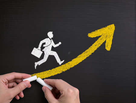 businessman running up on a chalkboard with an arrow going upの素材